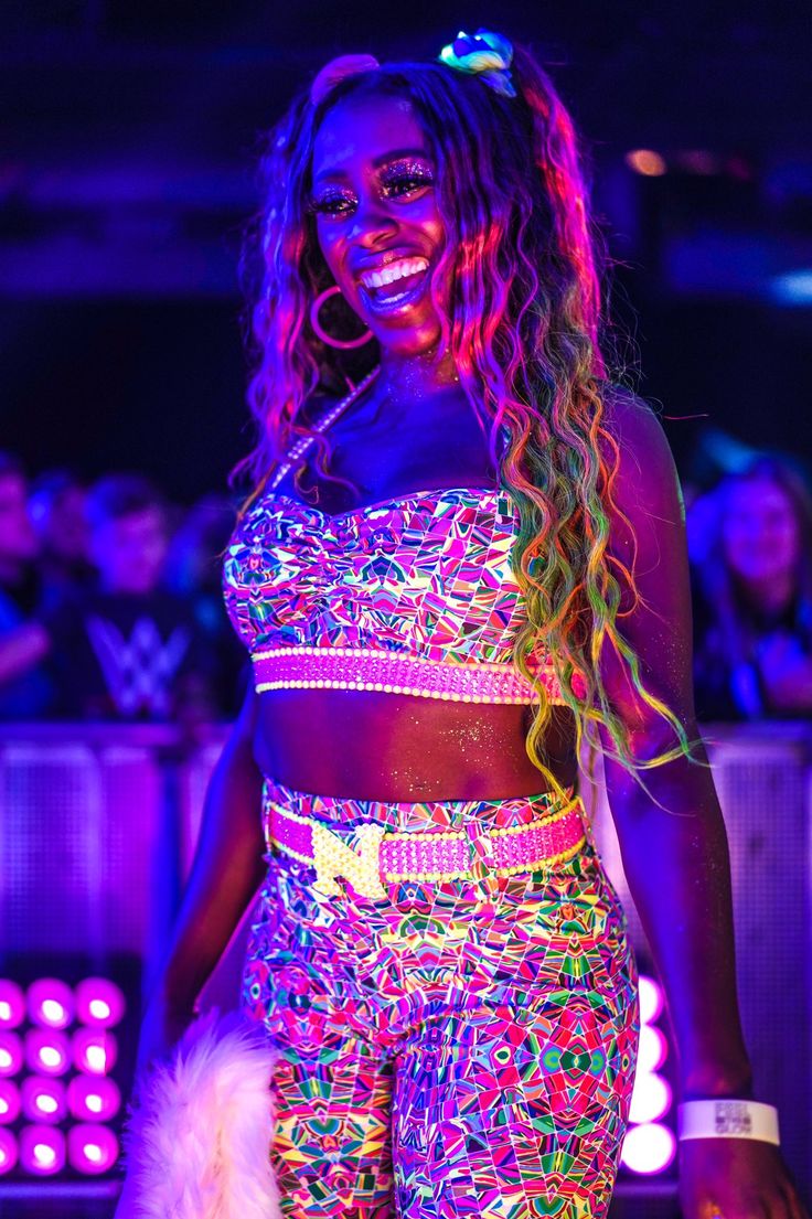 a woman standing in front of a purple light