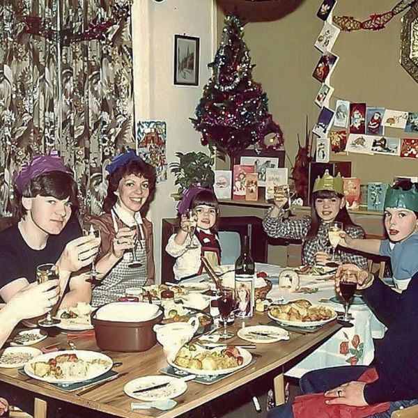 a group of people sitting around a table eating food