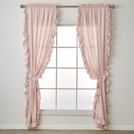 a window with pink ruffled curtains in front of a white wall and wooden floor