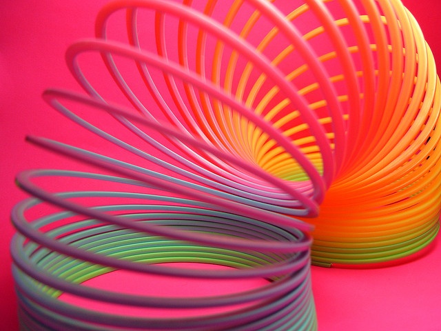 many different colored spirals on a pink background