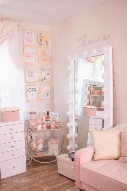 a room with a couch, mirror and dresser in it