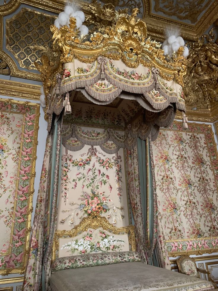 an ornate canopy bed with chandeliers and curtains