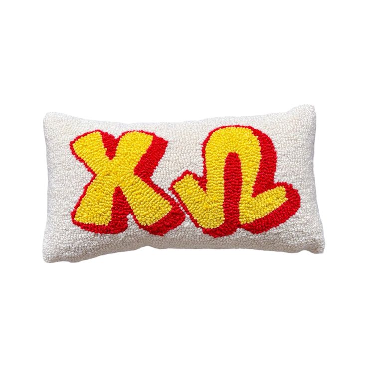 a white and red pillow with the letter kl on it