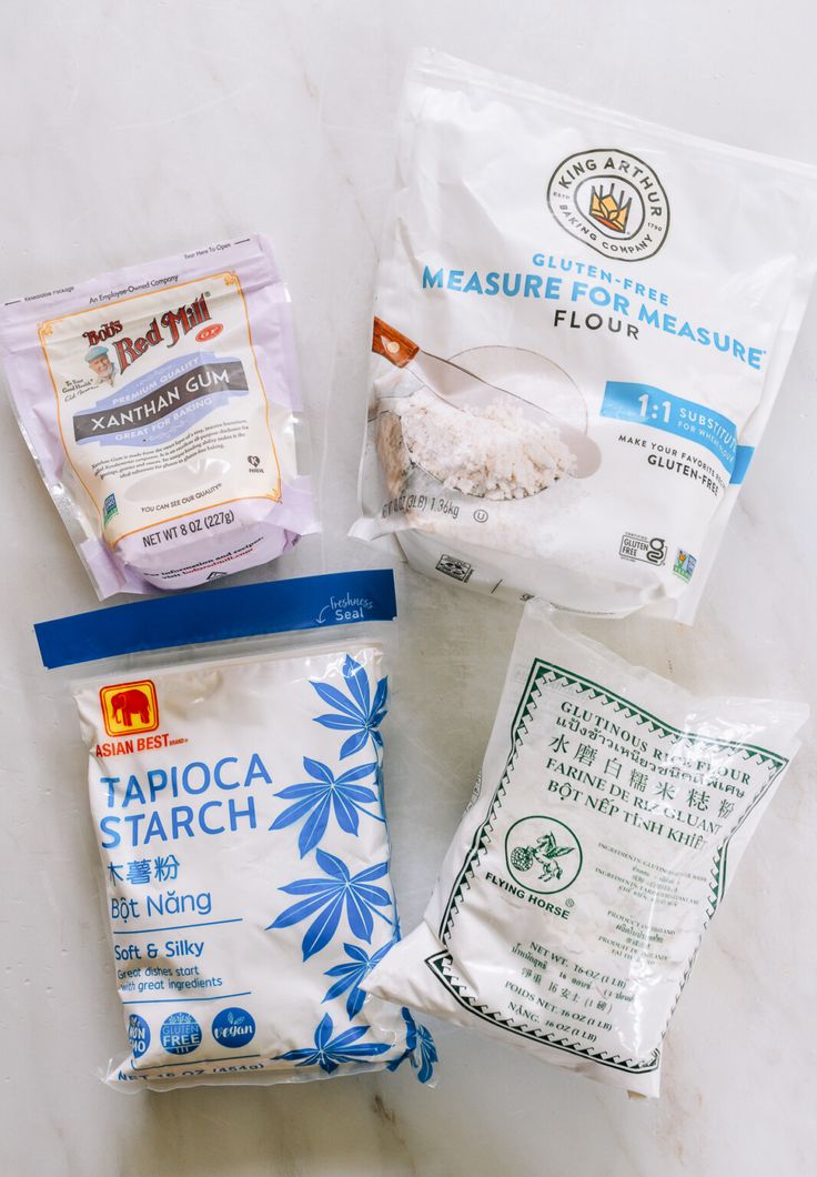 three bags of food sitting on top of a white counter next to each other,