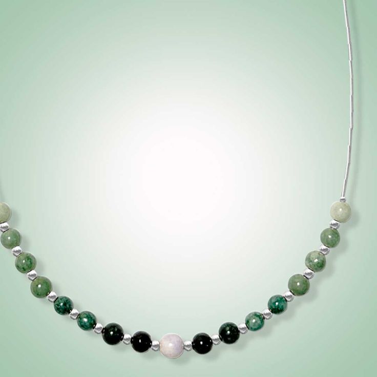 This dainty necklace is expertly crafted with beautiful jade beads of varying green shades and one delicate lavender jade focal bead in the center. The result is a stunning piece that exudes elegance and captures the eye. Mint, green, black and lavender jade (6mm) Length: 18" SELECT METAL Jade Necklaces With Natural Stones For May Birthstone, Elegant Green Crystal Necklace With Natural Stones, Elegant Aventurine Beaded Necklaces With Polished Beads, Elegant Jade Beaded Necklaces For Meditation, Elegant Aventurine Beaded Necklace With Polished Beads, Jade Emerald Necklace With Round Beads For Healing, Green Gemstone Beaded Necklaces For Meditation, Elegant Green Single Strand Crystal Necklaces, Elegant Green Crystal Necklaces With Polished Beads