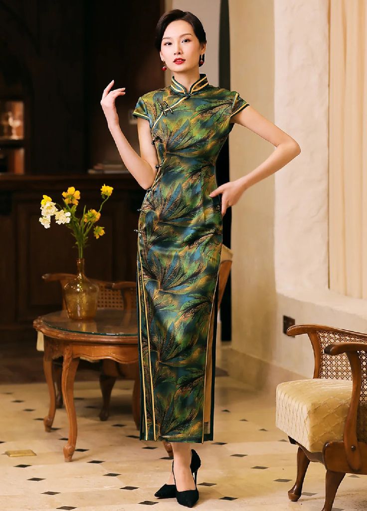 Brighten up any occasion in a green silk Chinese qipao dress. Inspired by Chinese vintage fashion this qipao dress exudes elegance and luxury. The pure silk fabric adds a luminous glow and dimension to the green Chinese female gown. Elegant Fitted Dark Green Dress, Green Short Sleeve Evening Dress For Banquet, Formal Green Silk Midi Dress, Elegant Dark Green Evening Dress, Elegant Green Dress With Stand Collar, Elegant Fitted Silk Cheongsam, Elegant Dark Green Dress For Banquet, Green Sheath Wedding Dress, Elegant Dark Green Banquet Dress