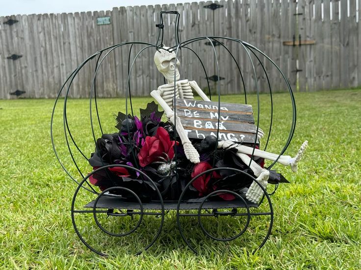 a skeleton sitting on top of a bench with flowers in it's back yard