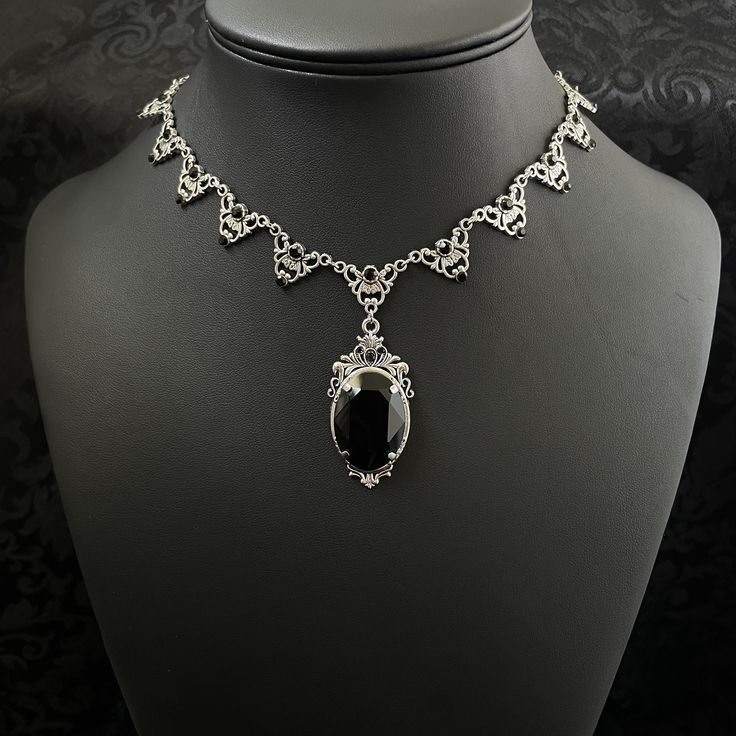 "This elegantly ornate necklace is made with antique silver tone centerpieces, featuring filigree and leaf details. Its mesmerizing design is accented with dazzling jet black glass crystals with a large high quality faceted jewel hanging at its center.  Decorated portion is 8 1/2\" wide and 2 1/4\" tall in the very center.  Necklace length is adjustable with soldered stainless steel cable chain, lobster clasp and extender. If you would like a different length, please send us a message. If you don't see items with a color you want, feel free to ask about availability." Ornate Formal Necklace With Oxidized Finish, Victorian Antique Silver Necklace, Victorian Antique Silver Metal Necklace, Antique Silver Victorian Metal Necklace, Formal Antique Silver Metal Necklace, Gothic Filigree Wedding Necklace, Ornate Silver Bridal Necklace, Gothic Filigree Necklace For Wedding, Formal Silver Filigree Bridal Necklace