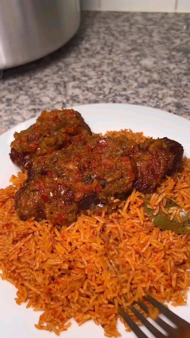 a white plate topped with rice and meat