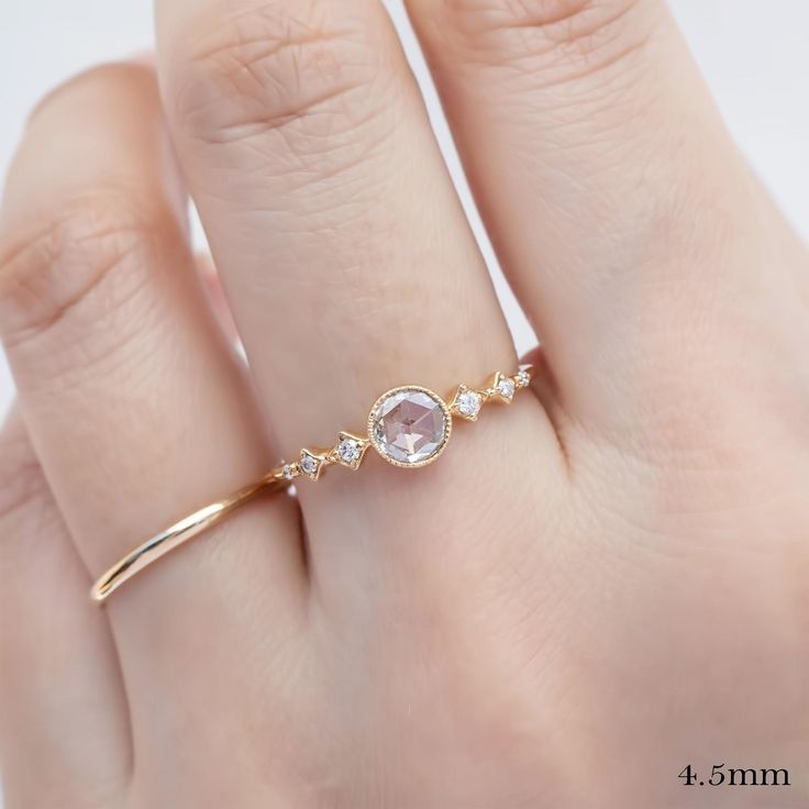 ✦ Current Inventory✦ 0.10ct yellow gold ring and 0.30ct yellow gold ring are in-stock in size 7. These will ship immediately in size 7, other sizes require 10 days to resize. Everything else is made-to-order and it takes 4 weeks. ✦ Main listing photo features 4.5mm diamond ring ✦ Video features top: 0.16ct diamond and bottom: 0.30ct Diamond ✦ Focal stone: natural rose-cut diamond ✦ GIA cert is optional 200) ✦ Bandwidth: approx. 1.4mm ✦ Accented with 0.05ctw natural earth-mined diamonds ✦ Low profile bezel setting ✦ Recycled solid 14k gold ✦ Packaged in a velvet ring box ✦ Handmade in NYC❤️ ✦ Buy this ring and receive 5% off coupon on your next purchase! 💎Focal Stone Size ✦ Near colorless, VS clarity, eye clean ✦ ≈4.0mm ≈0.10-0.20ct ✦ ≈4.5mm ≈0.20-0.30ct ✦ ≈5.0mm ≈0.30-0.35ct ✦ Please inqu Delicate Promise Ring With Rose Cut Diamonds, Dainty Stackable Rings With Rose Cut Diamonds For Anniversary, Delicate Rose Cut Diamond Proposal Ring, Delicate Rose Cut Promise Diamond Ring, Dainty Promise Birthstone Ring With Rose Cut Diamonds, Dainty Birthstone Promise Ring With Rose Cut Diamonds, Delicate Rose Cut Diamond Ring, Delicate 14k Gold Stackable Rings With Rose Cut Diamonds, Delicate Stackable 14k Gold Rings With Rose Cut Diamonds