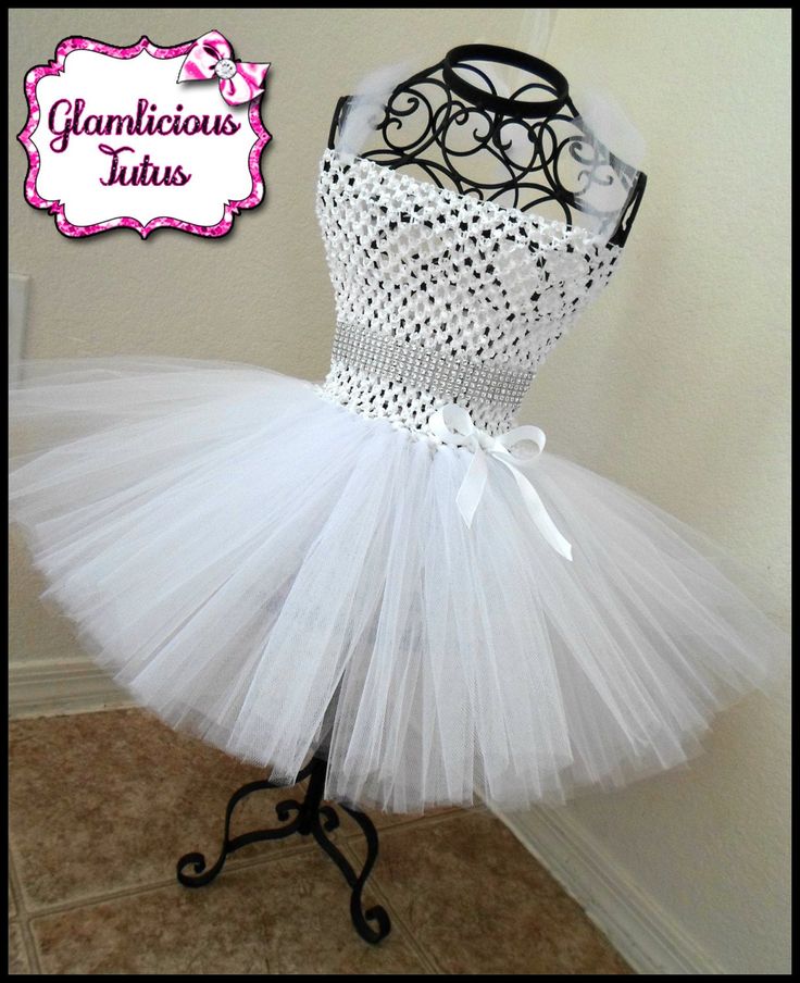 "Hello and welcome to my etsy store! What you are buying is a brand new handmade White tutu dress! The dress is made on a white crochet top! 6inch top for newborn-12 month old! 9 inches inch top for 2T-5T! 10 inches top for 6-8 girls! The dress is 2 1/2 layers of white tulle! (The tutu dress is very fluffy!) The top ties with tulle to make a halter top. The sash is grosgrain ribbon covered in rhinestone mesh and ties as a bow in the back. The tutu dress has an attached grosgrain ribbon bow on th White Tutu Dress, White Crochet Top, White Tutu, Grosgrain Ribbon Bows, Girls Tutu Dresses, Flower Girl Dresses Tutu, Girl Tutu, Flower Girl Tutu, White Tulle