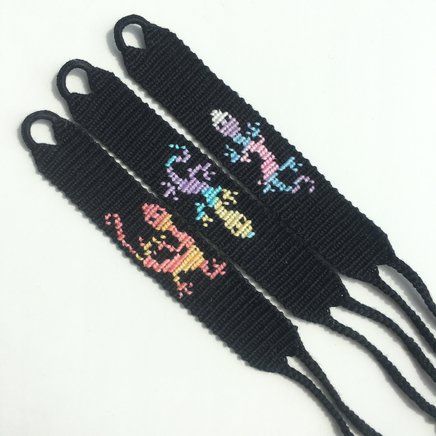 two black wristbands with cartoon characters on them