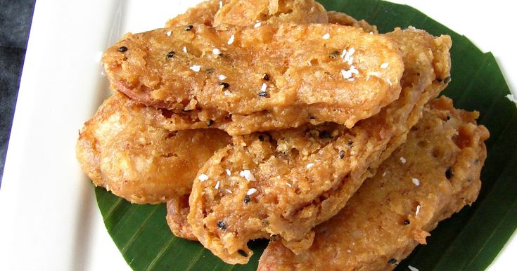 some fried food is on a plate with a banana leaf as the base for this dish