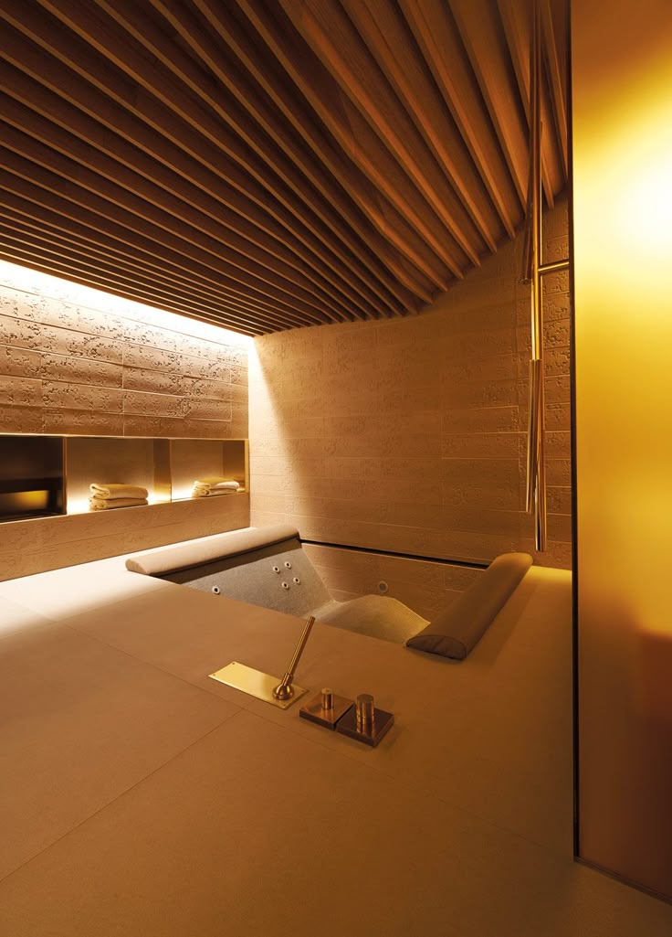 a room with a bathtub and lights on the ceiling