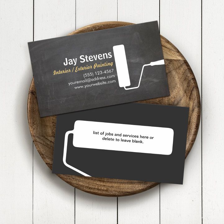 two business cards sitting on top of a wooden plate