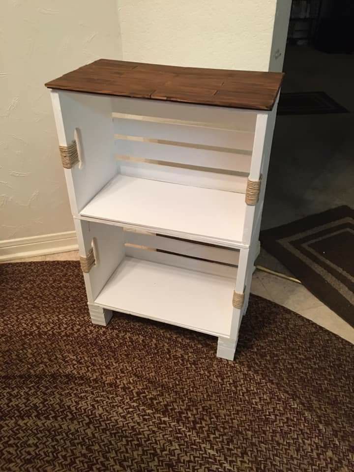 a small white shelf sitting on top of a carpeted floor