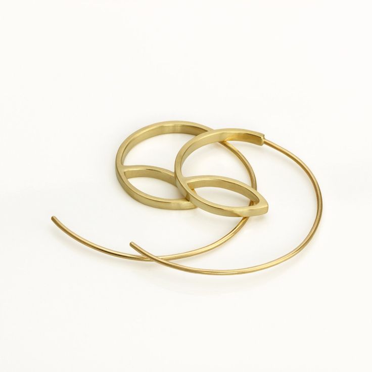 These are minimalist delicate gold hoop earrings, handmade of yellow 14k solid gold. I made these gold hoops of a rectangle gold wire, 2 mm wide x 1 mm thick. They have a delicate matte finish. Width of the delicate long ear wire (the wire that goes into the ear lobe) is 0.8 mm = about 0.3 inch.  These modern hoops are unique, and will add chic to any outfit. They are perfect for everyday's wear, as well as for a night out.  Elegant, minimal and eye catching. Total length of the earrings is 3.1 Minimalist Yellow Gold Hoop Earrings, Minimalist Single Hoop Earring In Recycled Gold, Minimalist Brass Wrap Earrings As Gift, Minimalist Tarnish Resistant Yellow Gold Wrap Earrings, Hand Forged 14k Gold Minimalist Earrings, Modern Yellow Gold Hoop Earrings In Recycled Gold, Minimalist Small Hoop Earrings In Recycled Gold, Modern Yellow Gold Open Circle Hoop Earrings, Modern Yellow Gold Open Hoop Earrings