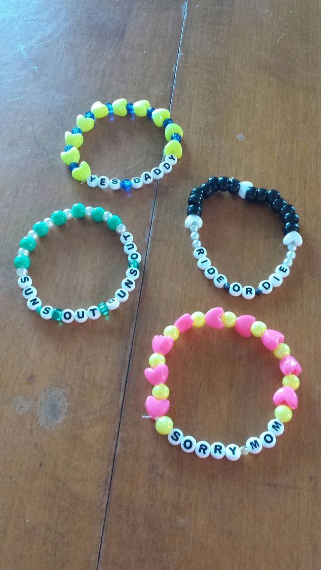 three bracelets sitting on top of a wooden table