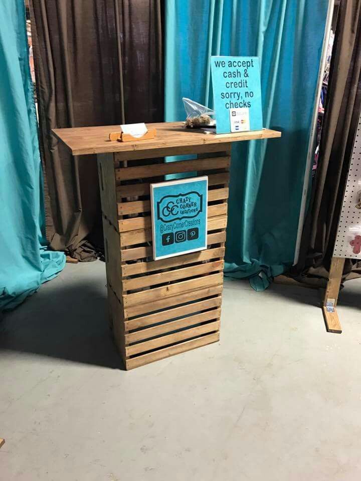 a table made out of pallets with a sign on it