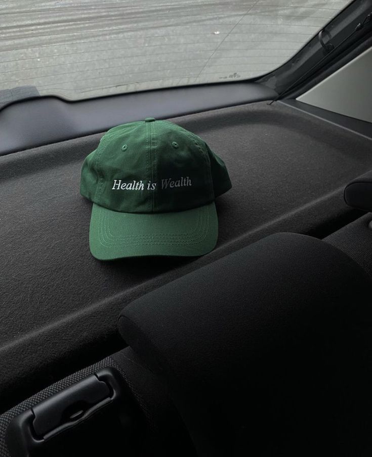 a green hat sitting on the dashboard of a car