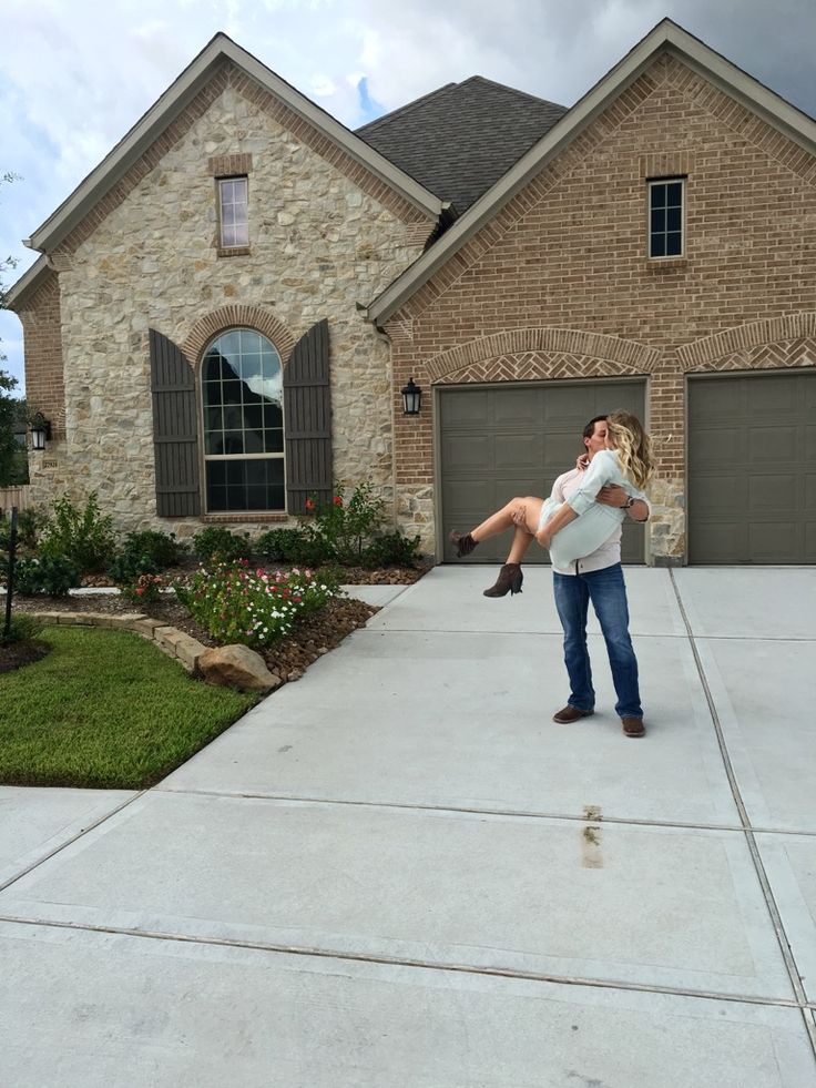 a man holding a woman in front of a house with the caption that reads, uploaded by kathy blun