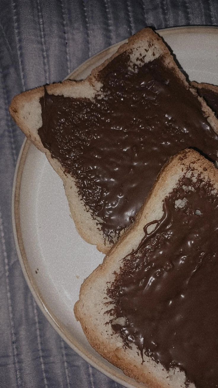 two pieces of bread with chocolate spread on them