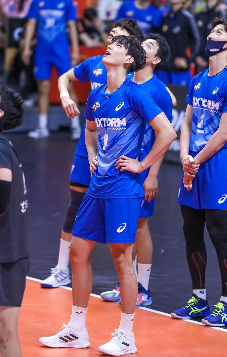 men in blue uniforms standing on a basketball court