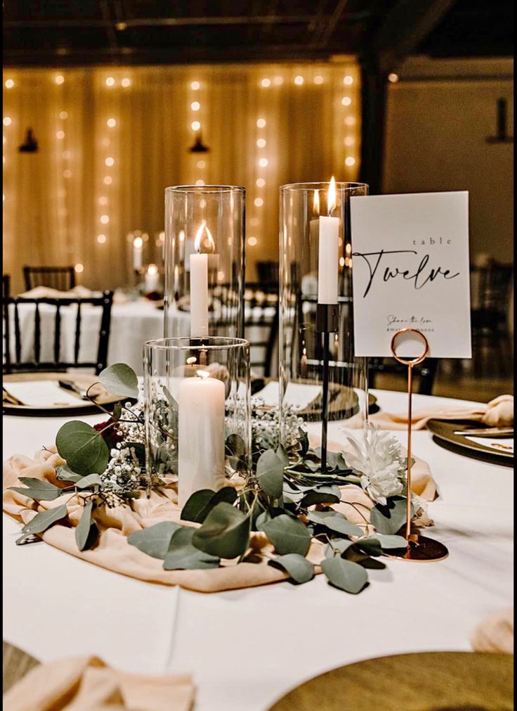 the table is set with candles and place cards