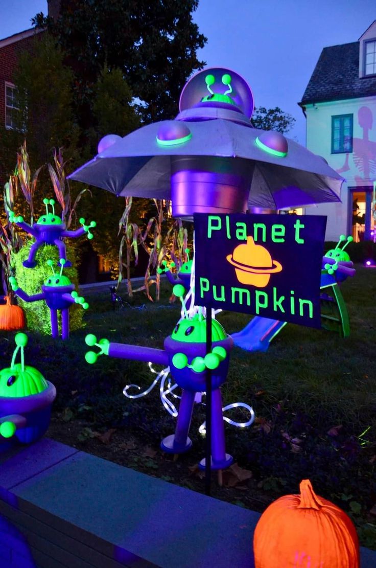 an outdoor halloween decoration with pumpkins and lights