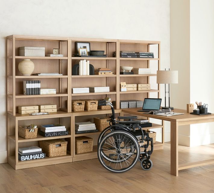 a wheelchair is parked in front of a bookshelf