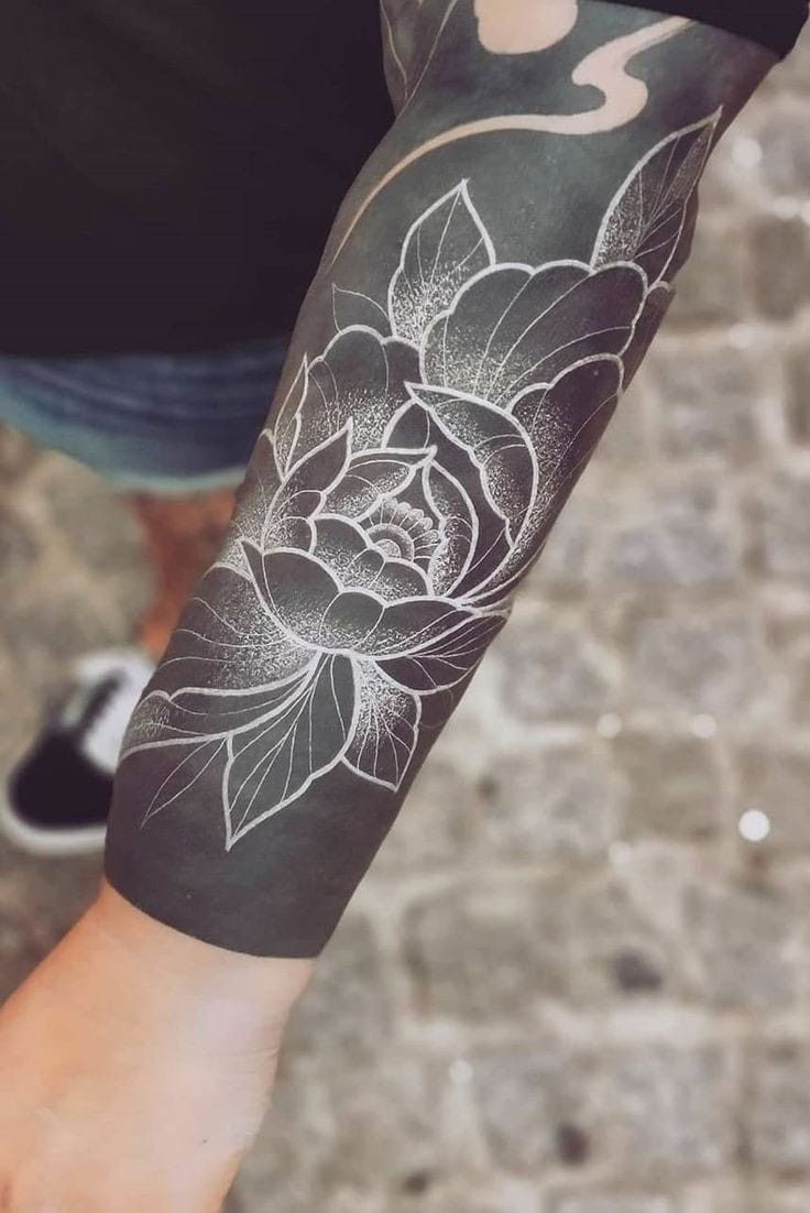 a person with a flower tattoo on their arm