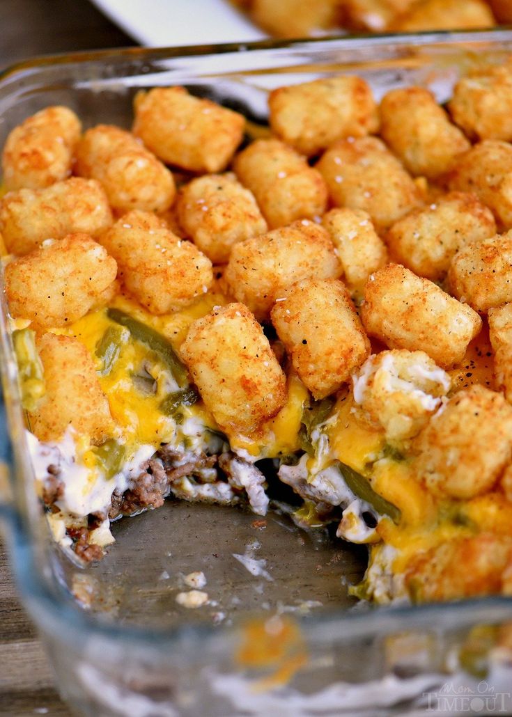 a casserole dish with tater tots in it and cheese on top