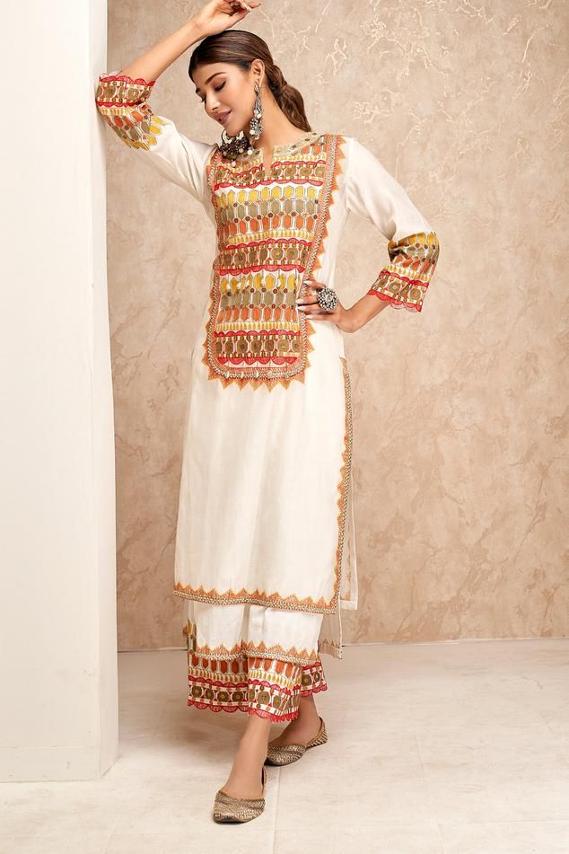 Yellow and white chanderi kurta with thread embroidery in geometric pattern and scallop trimmed sleeves. Paired with an inner, pant and embroidered dupatta.
Components: 4
Pattern: Embroidered
Type Of Work: Thread
Neckline: Round V
Sleeve Type: Three-quarter
Fabric: Chanderi, Cotton
Color: White,Yellow
Other Details: 
Weight: Approx 1000 gms
Length:
Kurta: 43 inches
Inner: 46 inches
Pant: 36 inches
Dupatta: 2.5 mtrs
Model height: 5 ft. 7 inches, wearing size S
Occasion: Mehendi and Haldi - Aza Fa White Palazzo Set With Gota Work For Eid, Eid White Palazzo Set With Gota Work, White Chikankari Embroidery Palazzo Set For Navratri, White Chikankari Palazzo Set For Navratri, Unstitched White Kurta With Gota Work, White Sharara With Embroidered Border And Straight Kurta, White Straight Kurta With Gota Work, Off White Straight Kurta Palazzo Set With Gota Work, White Chanderi Palazzo Set With Gota Work