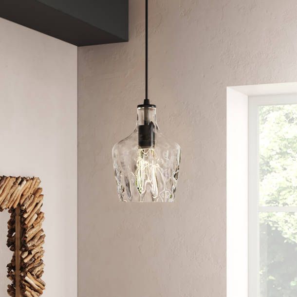 a glass light hanging from the ceiling in a room