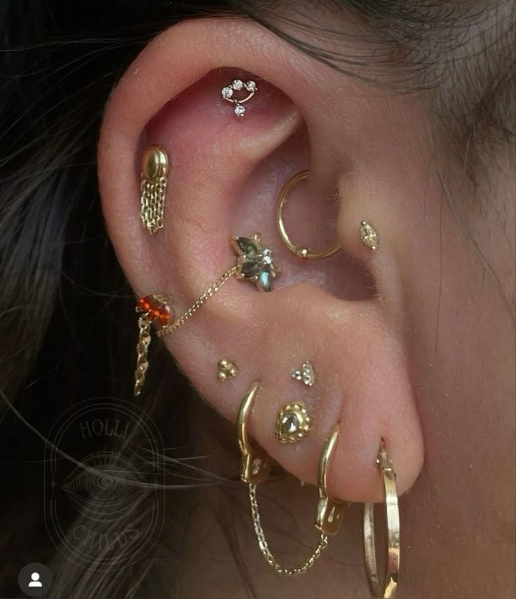 an ear with several different types of piercings on it