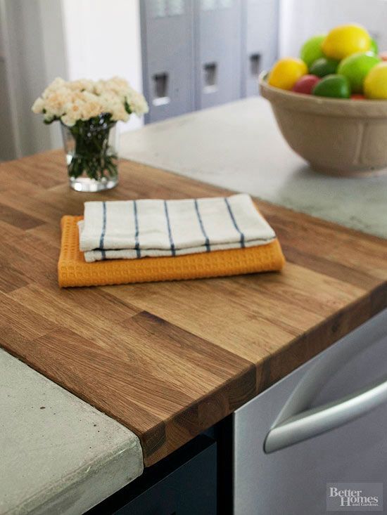 a kitchen counter with a bowl of fruit on it and a towel sitting on top