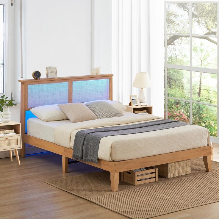 a bed sitting on top of a hard wood floor next to a dresser and window