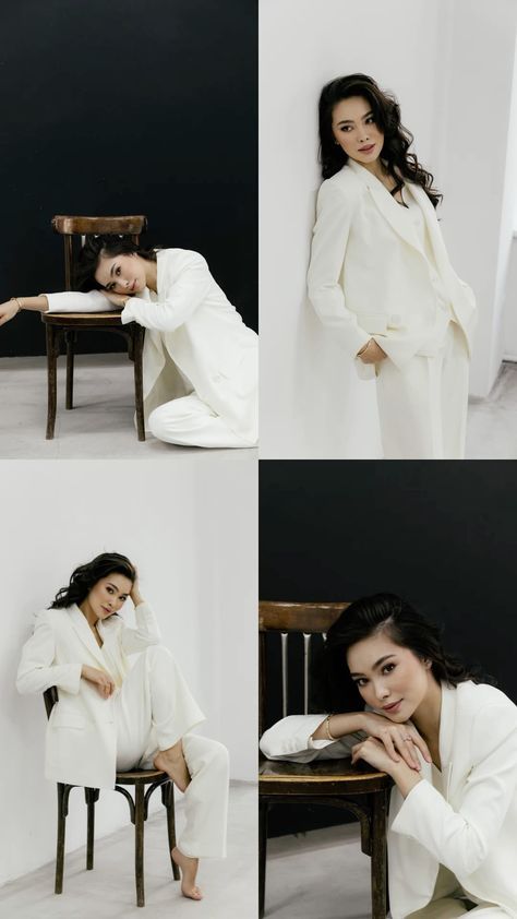 the woman is posing in all white for her photoshoots, and she's sitting on a chair