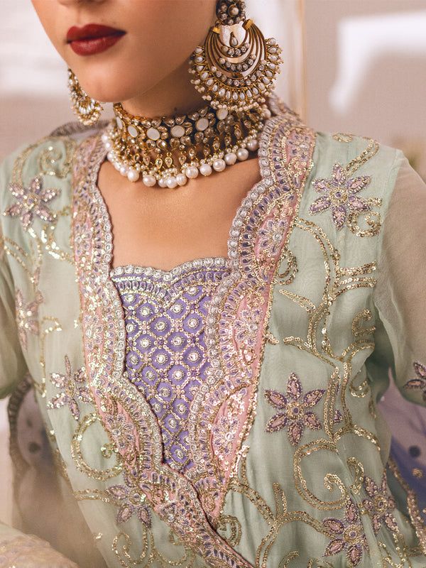 Luxury Mint Green Gown Style Lilac Sharara Pakistani Wedding Dress is a beautifully embroidered shirt is rendered in soft peach with thread and sequin detailing and paired with a ruffled dupatta and lace bordered trousers this chic and versatile formal will take you easily from daytime occasions to evening festivity. Embroidered Kameez: The perfectly crafted Pakistani Wedding Dress is adorned with intricate embroidery on the front, and sleeves making the elegant design. The neckline and sleeves Lilac Sharara, Mint Green Gown, Mint Gown, Pakistani Boutique, Pakistani Designer Clothes, Chiffon Sleeves, Pakistani Wedding Dress, Unstitched Dress Material, Gown Style