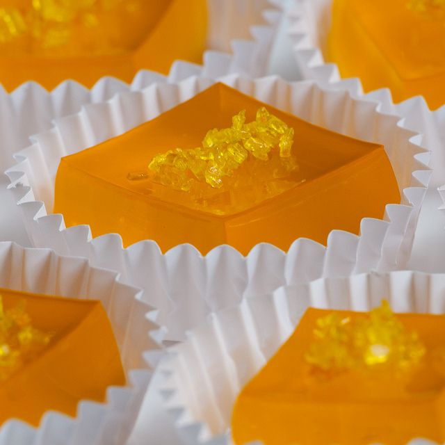 several orange and white boxes filled with yellow gummy bears