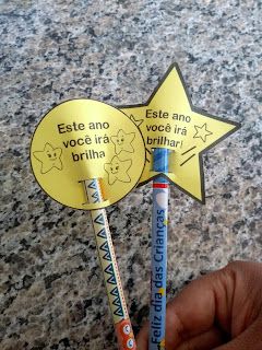 a person holding two toothbrushes with writing on them