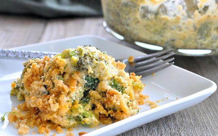 broccoli and cheese casserole on a plate with a fork next to it