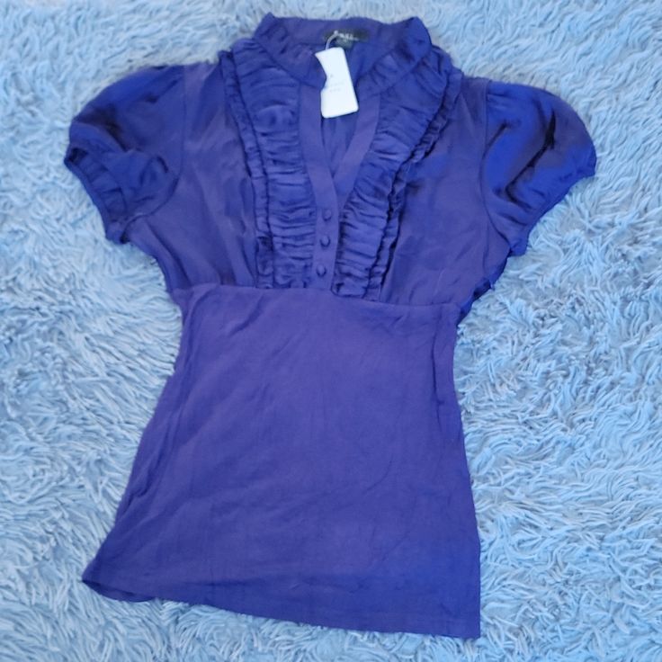 Nwt Cap Sleeves Ruffled Front Beautiful Rich Purple Fabric Empire Waist Collarless Covered Buttons V-Neckline Please View All Photos Make The Most Of Your 5 Lb Shipping Allowance By Bundling Shop With Confidence Posh Ambassador Top Rated Seller Fast Shipper Pet, Pest & Smoke Free Home Thank You For Shopping My Closet Fitted Forever 21 Blouse, Forever 21 Purple Tops For Spring, Forever 21 Purple Spring Top, Forever 21 V-neck Tops For Night Out, Chic V-neck Tops By Forever 21, Chic V-neck Top From Forever 21, Forever 21 V-neck Cotton Tops, Forever 21 V-neck Blouse For Night Out, Fitted V-neck Blouse From Forever 21