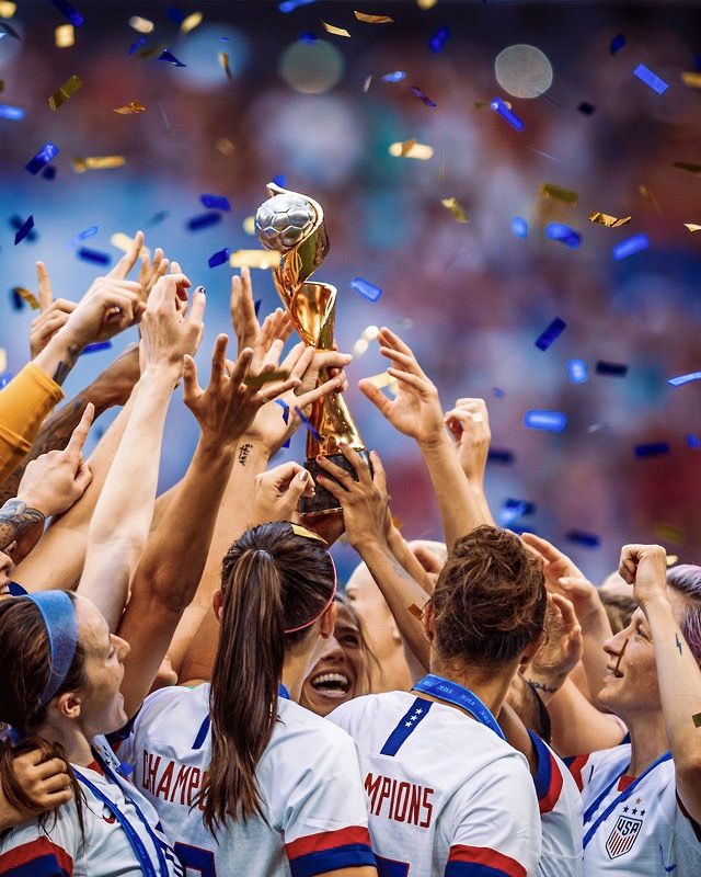 the women's soccer team is celebrating with their trophy