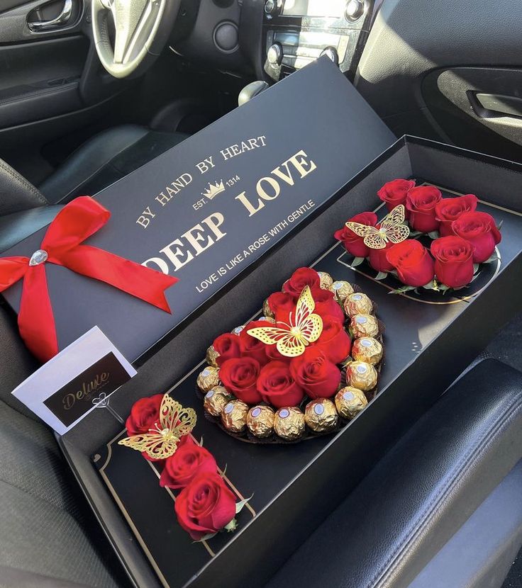 two valentine's day gifts in a car with red roses and chocolates on display