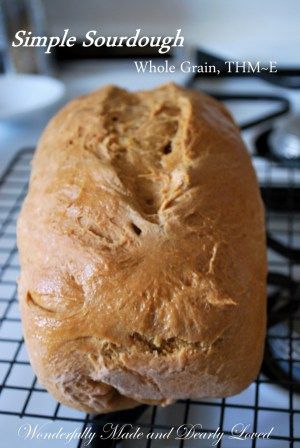 a loaf of bread sitting on top of a cooling rack with the words simple sourdough whole grain, thm - f