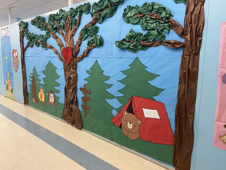 a classroom wall decorated with trees and animals