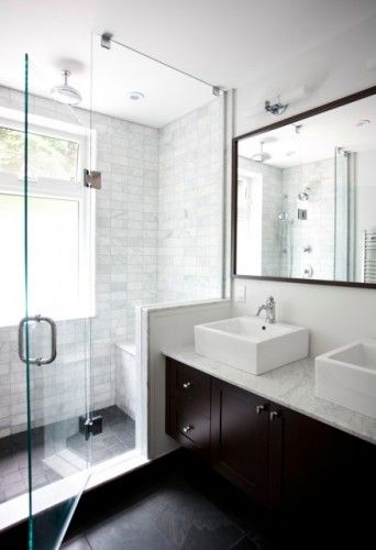 a bathroom with two sinks and a shower