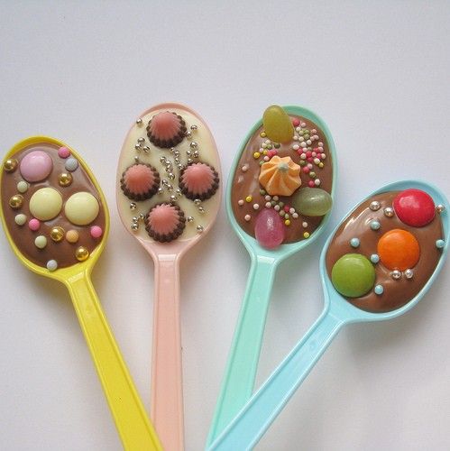 five spoons with different types of candies in them