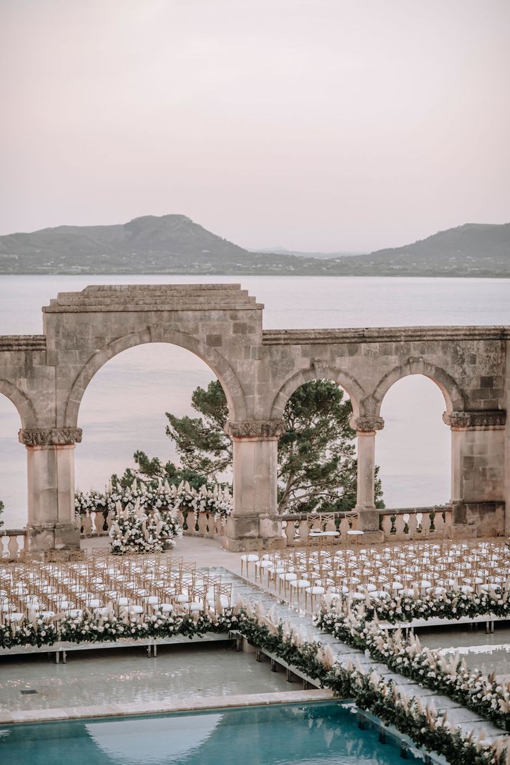 an outdoor ceremony set up by the water